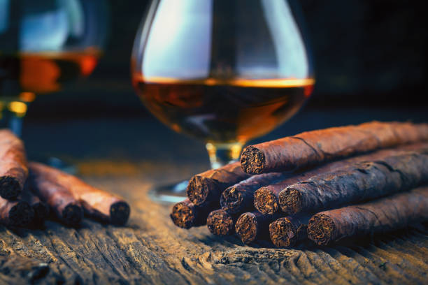 quality cigars and cognac quality cigars and cognac on an old wooden table cigar photos stock pictures, royalty-free photos & images
