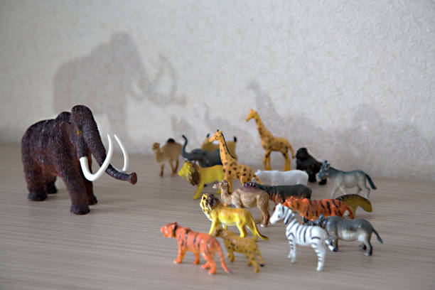 istock Wild animals against a huge prehistoric mammoth 1192111217