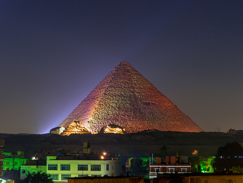 View of the Great Pyramid of Giza illuminated at night. In Cairo, Egypt