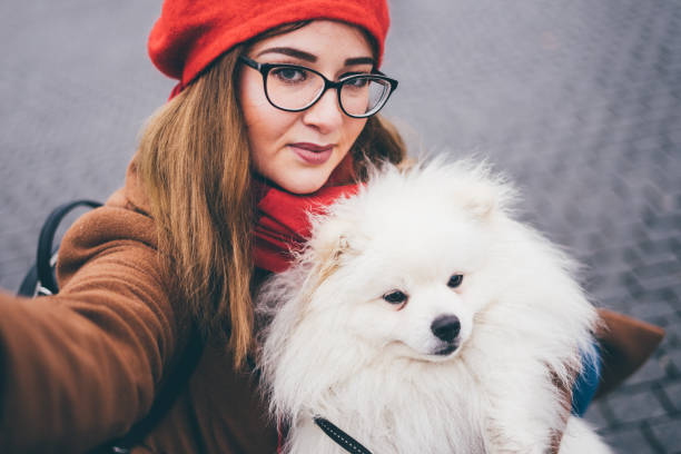 istock Girl makes selfie with a white pomeranian. 1192113390