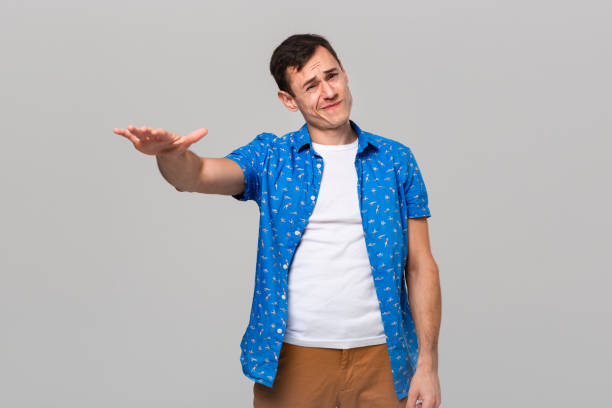 istock Man in uncertain if he likes or dislikes the object. 1192114747