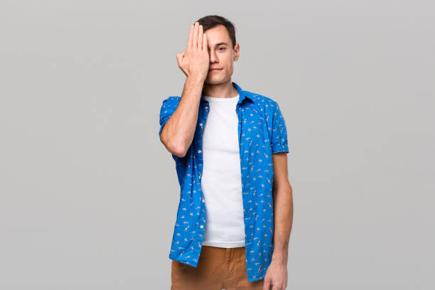 istock Young man covering eyes with hands. Gesture of three wise monkeys. 1192114786