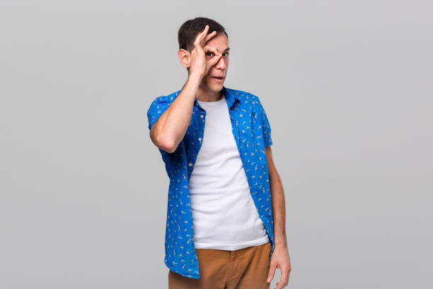 istock Handsome man looking in the distance isolated over grey background. 1192114856