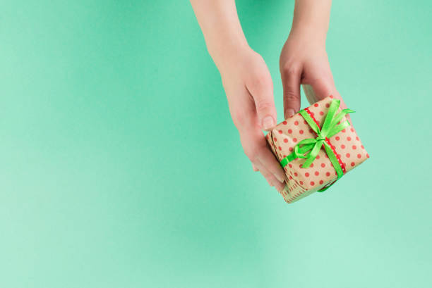 istock Present in woman hand on a green background. 1192115285