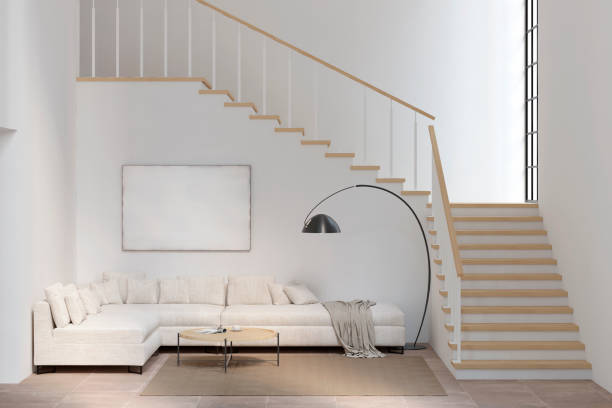 istock White living room with sofa, blank canvas, coffee table, lamp, and stairs. 1192115581