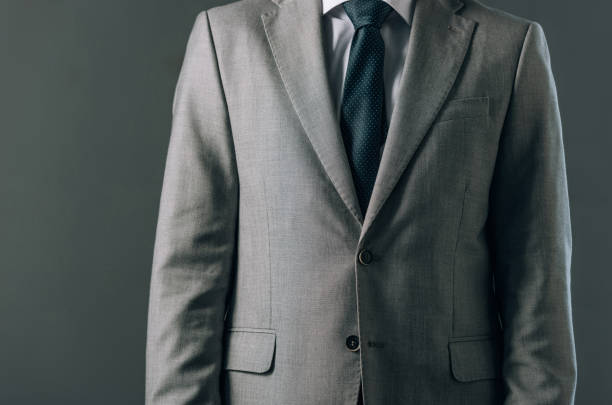 istock Cropped view of man in suit isolated on grey 1192116786