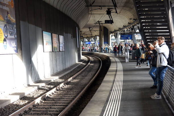 Zürich Stadelhofen is a local railway station in the city of Zürich. Stadelhofen station opened in 1894 and completely rebult in 1990 as part of the new Zurich S-Bahn. The main architect of the changes made 1990 was Santiago Calatrava. The image shows the main platform with several passengers awaiting the next connections.