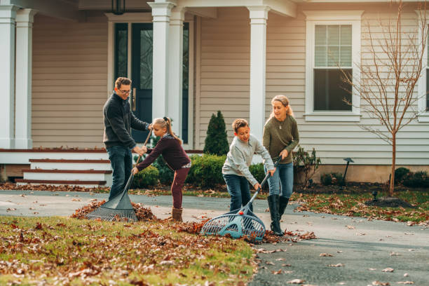 istock Hardworking Family Raking Autumn Leaves 1192119404