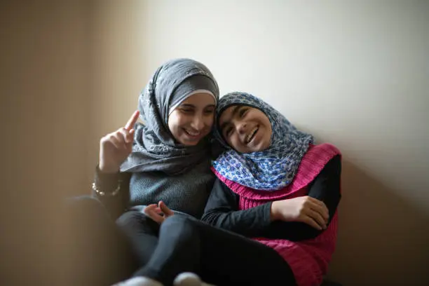 Photo of Muslim Sisters Cuddling stock photo