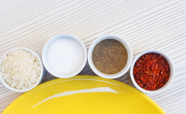 Salt rice with pepper, in small bowls stock photo