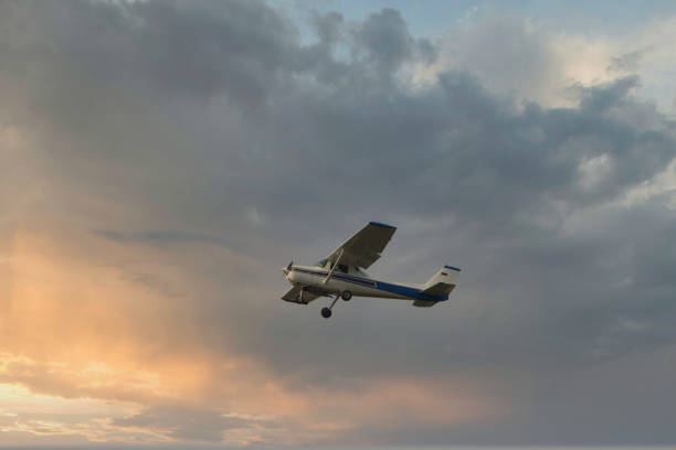 istock plane flying at sunset in the clouds 1192124574