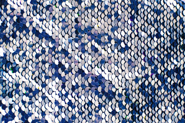 istock Pieces of cloth with blue and silver sequins. Glitter background. Sequin texture 1192125360