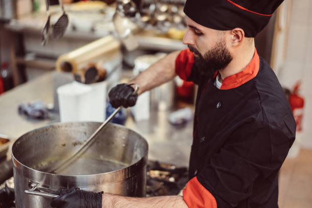 istock Male chef cooking in restaurant 1192128474