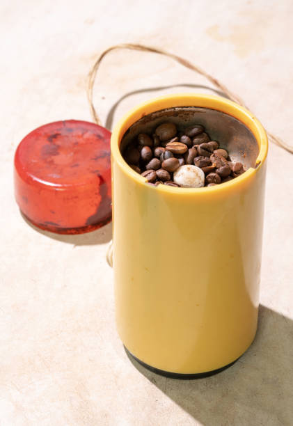 old yellow coffee grinder with red lid