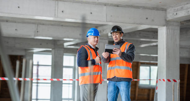 istock Investor Expressing His Wishes To Construction Foreman At A Construction Site 1192130194