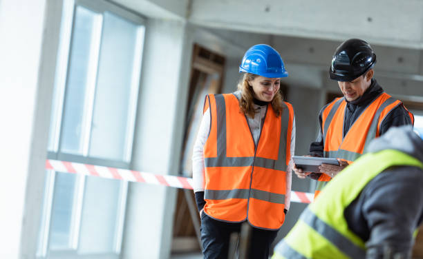istock Female Architect And Construction Foreman Talking At A Construction Site 1192130197