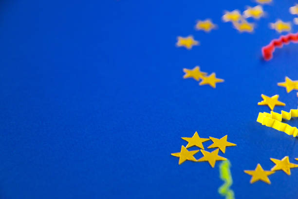 istock Bright holiday background, flatlay props stars and serpentine on blue background copy space 1192131414