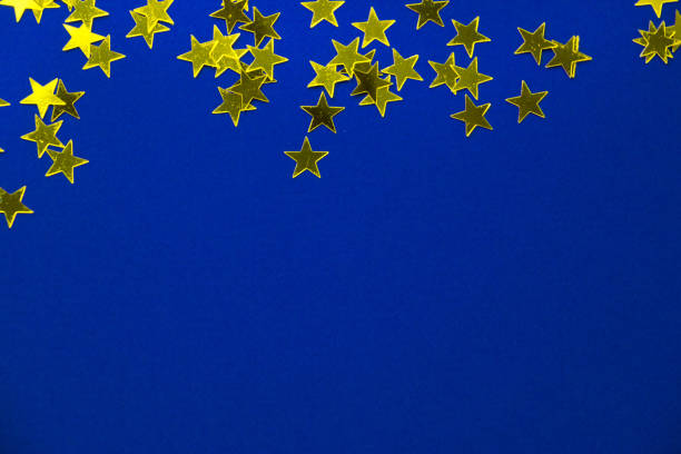 istock Bright holiday background, flatlay props stars on blue background copy space 1192131453