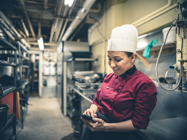 istock Female Chef with mobile phone 1192131958
