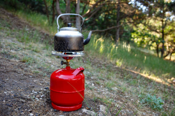 istock Cooking camping kettle on a red gas bottle. 1192134569