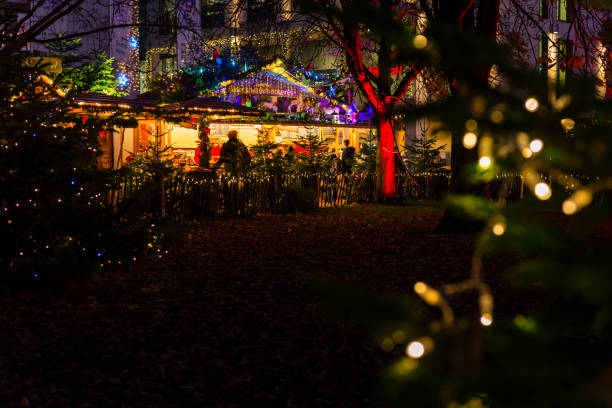 Karlsruhe, Germany - December 03, 2019: colorful christmas market in Karlsruhe with lot of huts between illuminated trees
