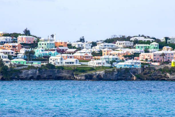 Arriving at the Island of Bermuda we see Colorful Homes on a hillside overlooking the Atlantic Ocean stock photo