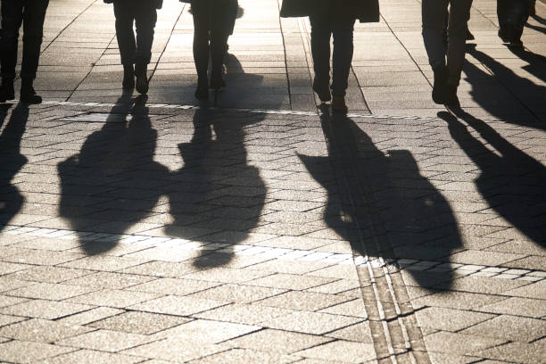 istock Persons walking in the city, shadows visible 1192141097