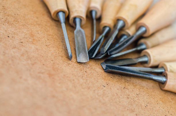 Tools for woodcarving on rough background close up. Craftmanship equipment concept