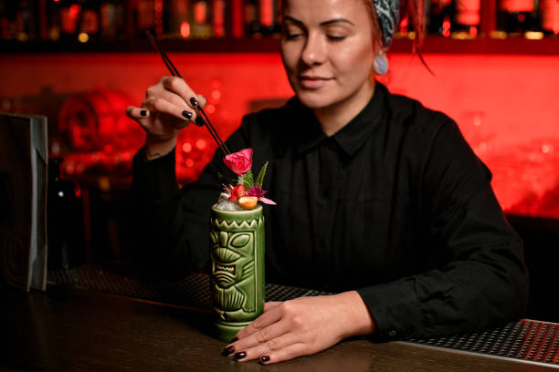istock Bartender decorating an alcohol cocktail with flowers 1192144950