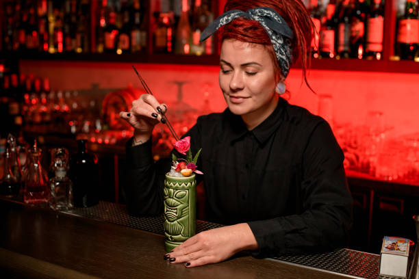 istock Bartender decorating an alcohol drink with flowers 1192144967