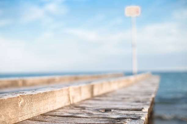 Wooden deck by the sea Wooden deck by the sea in a calm sunny day cielo minaccioso stock pictures, royalty-free photos & images