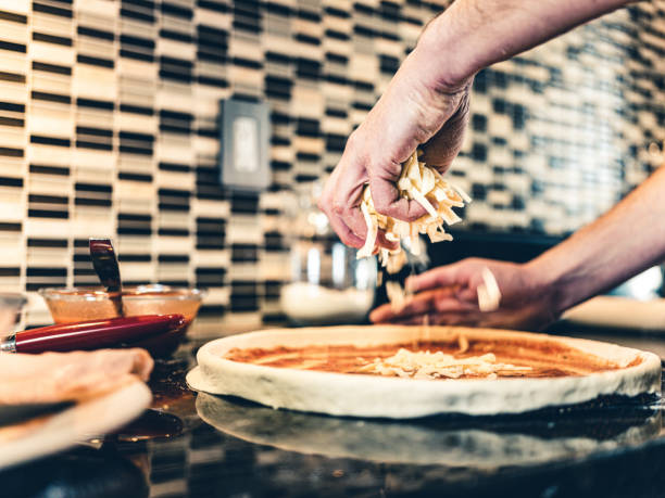 istock Hands of Man making pizza 1192145832