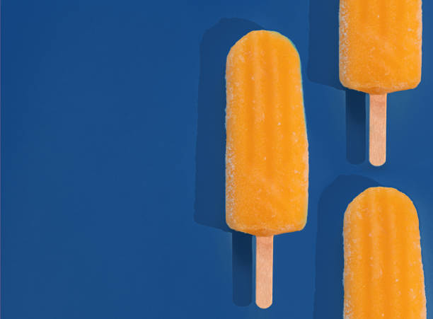 istock minimalism composition. orange ice cream on a classic blue background 1192146418