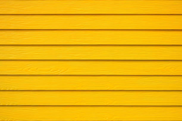 istock Wall panel paint yellow color synthetic wooden plank texture surface background.Outdoor panel engineered wood nature pattern or abstract backdrop vintage lines,summer design and decoration.Soft image. 1192146738