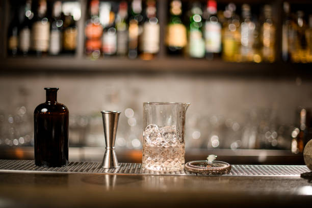 istock Bottle, jigger and glass with ice and alcohol 1192146750