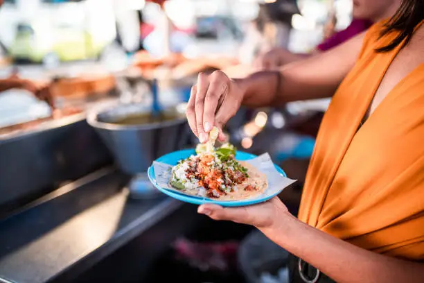 Women holding the plate with a taco on it