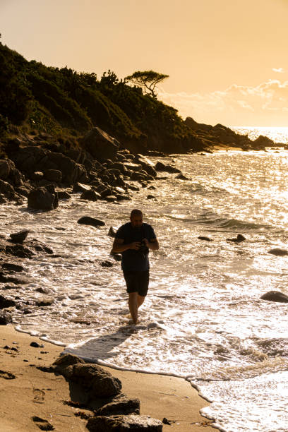 istock Man taking a photos with dslr camera outdoors, on the beach 1192148204
