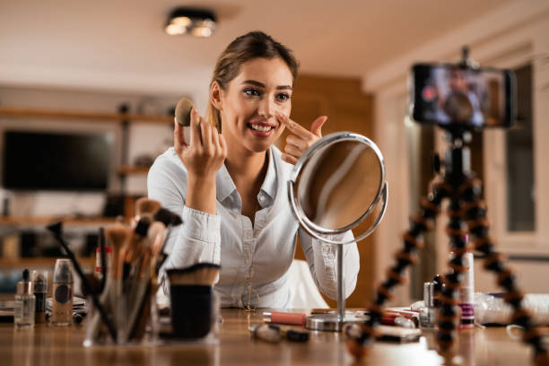 istock Beautiful woman vlogging about applying make-up foundation. 1192148384