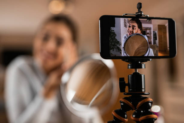 istock Close-up of woman doing make-up tutorial for her vlog. 1192148414