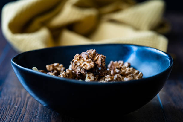 istock Walnut Kernels and Whole walnuts in Porcelain Bowl. 1192149597
