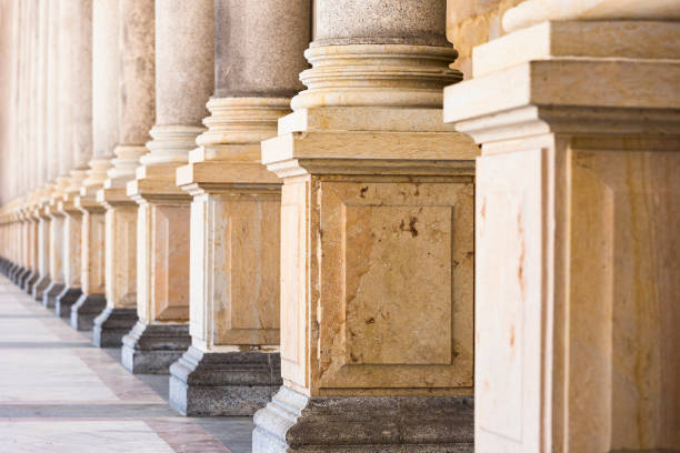 istock Colonnade, row of classical stone columns, background with copy spaced 1192149720