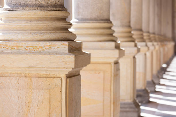 istock Colonnade, row of classical stone columns, background with copy spaced 1192150005