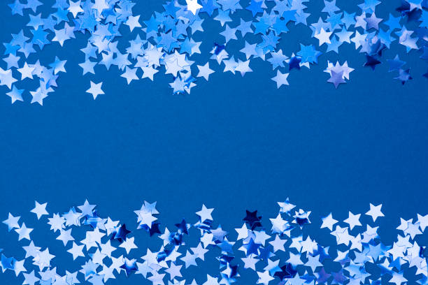 istock Blue abstract Christmas background border, frame texture with stars confetti on blue background. Space for text. 1192150186