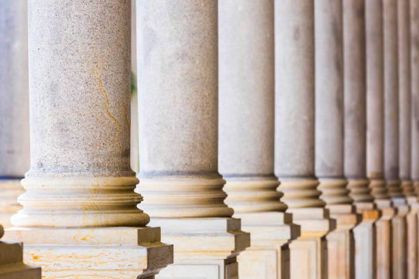 istock Colonnade, row of classical stone columns, background with copy spaced 1192151482