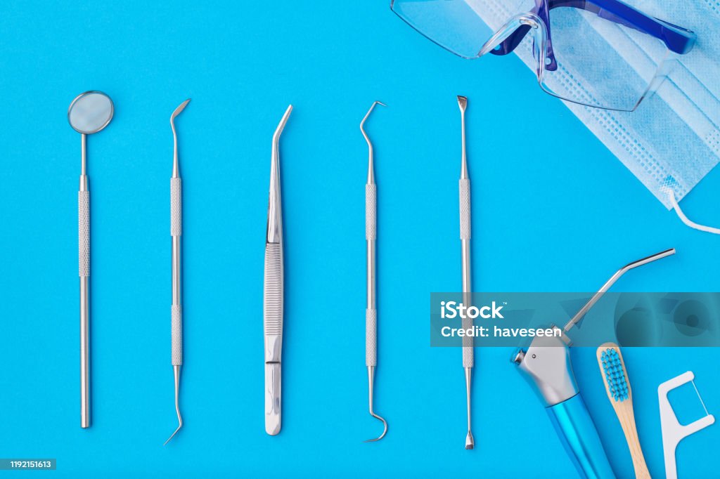 Dentist tools over blue background top view Dentist tools over blue background top view flat lay. Tooth care, dental hygiene and health concept. Backgrounds Stock Photo