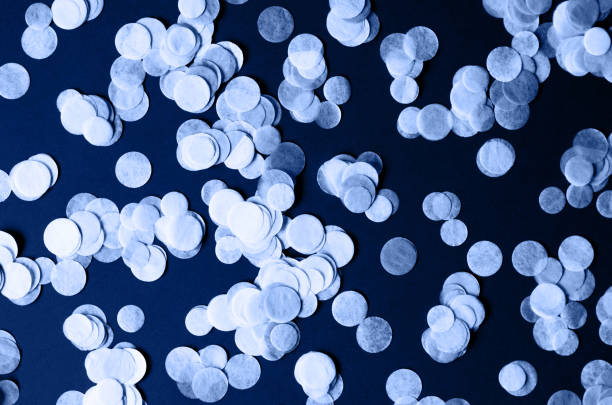 istock Dark background with round confetti in classic blue. 1192152491