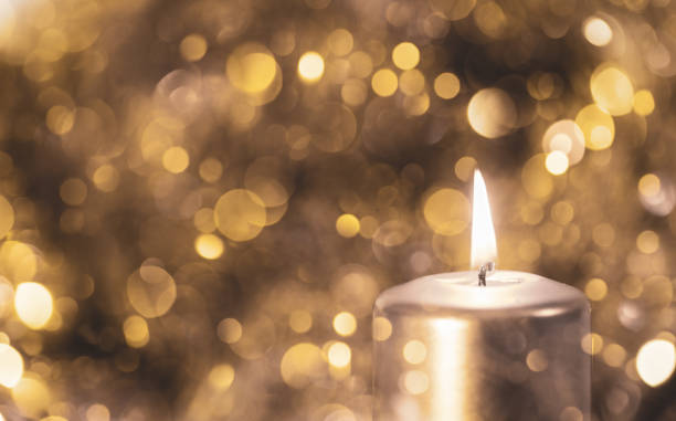 istock Christmas Candle on a Golden Bokeh Background 1192153988