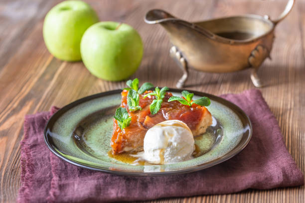Portion of tarte Tatin Portion of tarte Tatin decorated with fresh mint and served with ball of ice-cream ice pie photography stock pictures, royalty-free photos & images