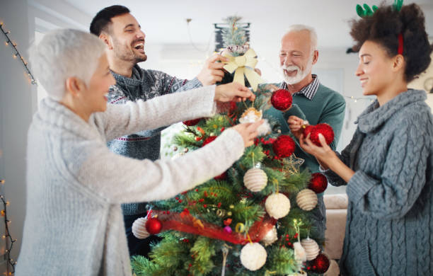 istock Family decorating a Christmas tree. 1192155034