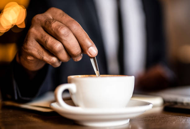 istock Businessman mixing coffee hand close up. 1192155368